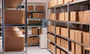 Storage room with metal shelves filled with brown cardboard boxes